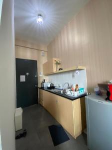 a small kitchen with a sink and a refrigerator at 214 Nana's Homes Netflix n WiFi in Petaling Jaya