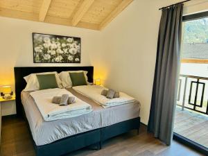 a bedroom with a bed with two pillows on it at Chalet near Lake Pressegger and Nassfeld ski area in Hermagor