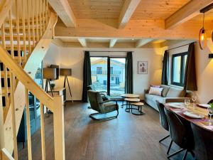 a living room with wooden ceilings and a staircase at Chalet near Lake Pressegger and Nassfeld ski area in Hermagor