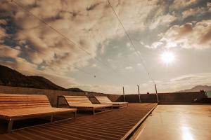 a group of benches sitting on top of a roof at Gangjin K-Stay Tourist Hotel in Kangjin