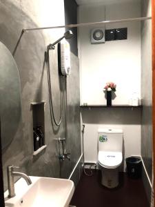a bathroom with a toilet and a sink and a shower at nine guesthouse in Ban Pa Tung (7)