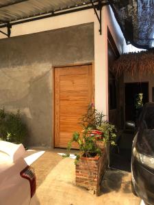 a wooden door on the side of a house at nine guesthouse in Ban Pa Tung (7)