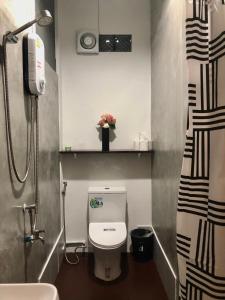 a small bathroom with a toilet and a shower at nine guesthouse in Ban Pa Tung (7)