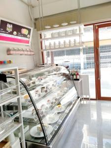 a bakery with a display case in a store at Sweety Secret Guesthouse in Ban Tambon Bang Khae +18 photos