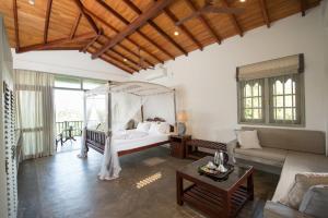 a bedroom with a bed and a living room at The Horizon Hill Top Villa in Unawatuna +37 photos