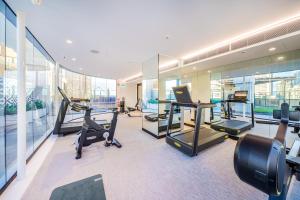 a gym with treadmills and exercise equipment in a building at Oaks Sydney Hyde Park Suites in Sydney +50 photos