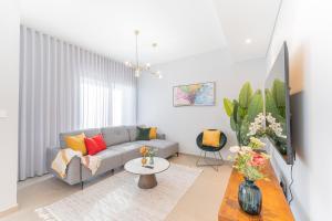 uma sala de estar com um sofá e uma mesa em Cosy Luxury villa Tilal Alghaf no Dubai