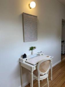 a white desk with a chair in a room at Writer's Cottage, luxurious oasis in the heart of North Hobart in Hobart
