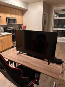 a large flat screen tv sitting on top of a table at Entire 1-Bedroom Apartment In Downtown Portland in Portland