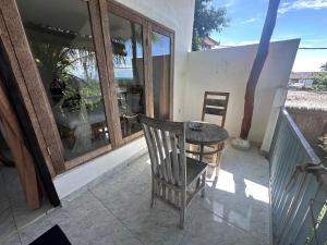 a chair and a table on a balcony at Azona Greens Uluwatu in Uluwatu