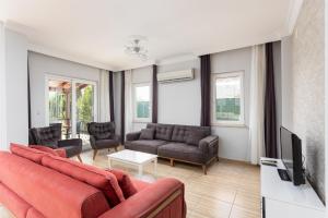 un salon avec un canapé et une télévision dans l'établissement Villa Magnolia, à Dalyan