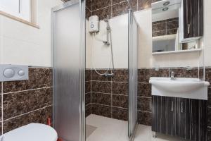 a bathroom with a shower and a sink at Villa Magnolia in Dalyan +15 photos