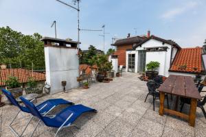 a patio with chairs and a table on a house at The Liberty Terrace in Udine