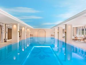 a swimming pool in the middle of a building at The Azure Qiantang, a Luxury Collection Hotel, Hangzhou in Hangzhou