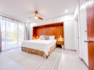a bedroom with a large bed and a desk at The Palms Resort in Saint James