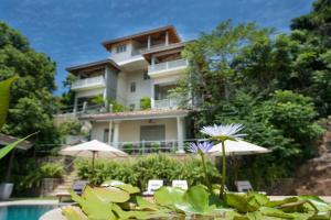 a building with a pool in front of a house at The Horizon Hill Top Villa in Unawatuna