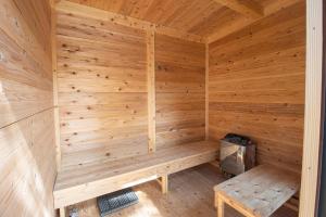 a wooden sauna with a bench in it at GLOCE 射水 禅楽 築150年の古民家でプライベートサウナ体験 in Imizu