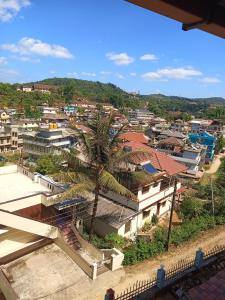 a view of a city with a palm tree at Coorg Vacation Stay(KKR) in Madikeri