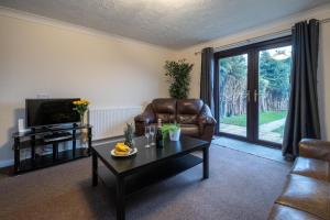 a living room with a couch and a coffee table at 52 Carr Avenue in Leiston
