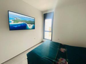 a bedroom with a bed with a painting on the wall at New- Luxury Glil Yam For Family 4 Rooms Parking in Herzliya