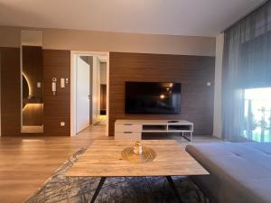 a living room with a television and a coffee table at Karzo Property LK 202 in Budapest