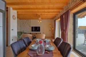 a dining room with a wooden table and chairs at Villa Tasila 2 