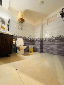 a bathroom with a toilet and a camera on the wall at Himalayan Riverside Resort, Manali in Manāli