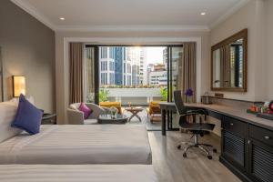a hotel room with a bed and a desk at Boulevard Hotel Bangkok Sukhumvit in Bangkok