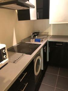 a kitchen with a sink and a washing machine at Coeur Vieil Antibes Plages à Pied in Antibes