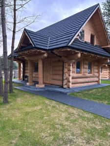 a log cabin with a black roof at OŚRODEK U POLAKA domki góralskie 