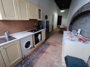 a kitchen with white cabinets and a stove top oven at casa vacanze San Lorenzo in Viterbo