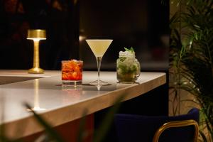 a table with two cocktails and a glass on it at Crowne Plaza Madrid - Centre Retiro, an IHG Hotel in Madrid