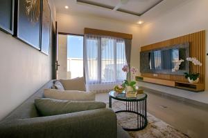 a living room with a couch and a table at Taman Seminyak Suites in Seminyak