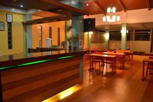 a bar in a restaurant with tables and chairs at Julieta's Pension House in Puerto Princesa City