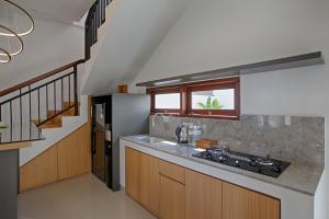 a kitchen with a sink and a counter top at Taman Seminyak Suites in Seminyak