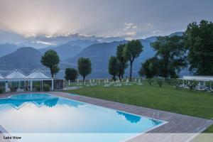 a swimming pool with a view of mountains at Seven Park Hotel Lake Como - Adults Only in Colico