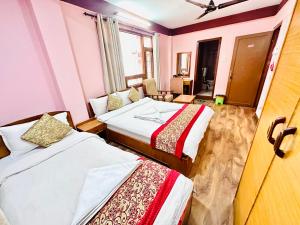 Postel nebo postele na pokoji v ubytování Hotel Green Orchid