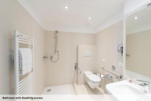 a bathroom with a shower and a toilet and a sink at Seven Park Hotel Lake Como - Adults Only in Colico