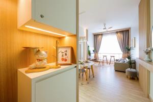 a room with a kitchen and a living room at MujiZen Retreat Seaview Apartment Amber Cove in Melaka
