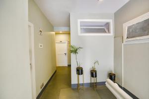 a hallway with two potted plants in a house at FabHotel Monalisa in Manāli