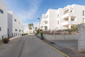 an empty street in front of a white building at Paraiso Costero - Adults Only - in Conil de la Frontera