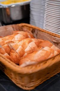 a basket of bread sitting on a table at Travelodge Honmachi Osaka in Osaka