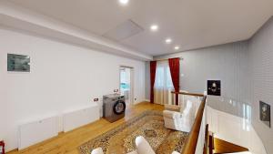 a living room with a couch and a tv at Villa Casablanca in Braşov