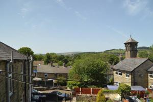 a view of a small town with a clock tower at Glossop Retreat 1 King2 Dbl Cottage in Glossop