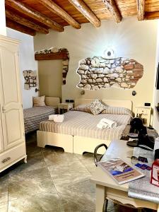 a bedroom with two beds and a stone wall at CQ Rooms Verona in Verona