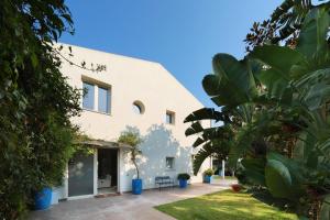 an external view of a house with plants at Salicornia - Sea view villa with pool in Marsala