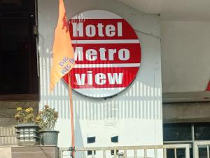 a hotel metro view sign on the side of a building at Metroview rooms & hotel in Bahādurgarh