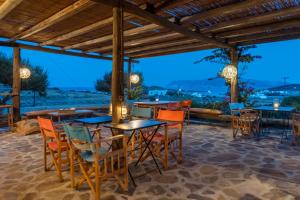 a restaurant with tables and chairs and a view at Kimolia Gi in Kimolos
