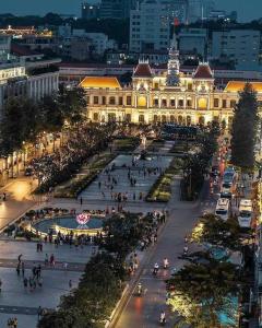 a large building with people walking in front of it at Ben Thanh_Unique Vietnamese cultural house_Bathtub in Ho Chi Minh City