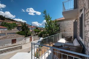 a balcony with chairs and a view of a city at Kondias Experience in Kondiás